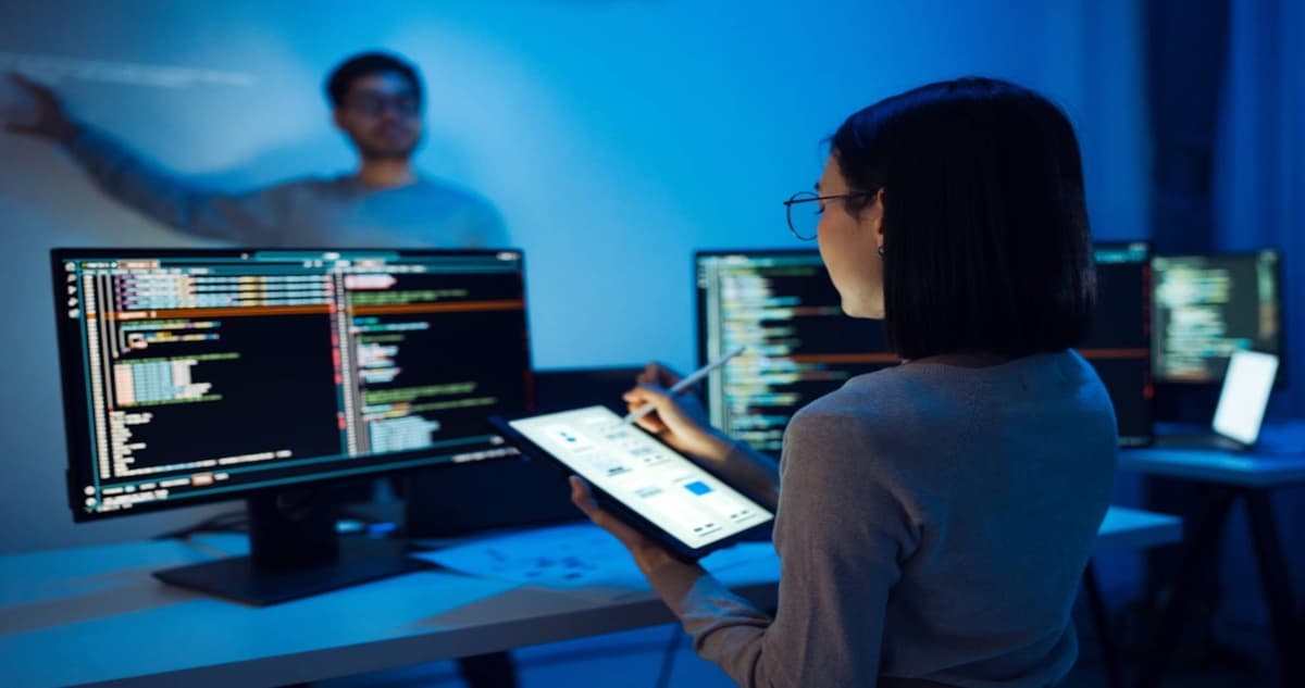 Human tech workers collaborating with AI systems to enhance productivity